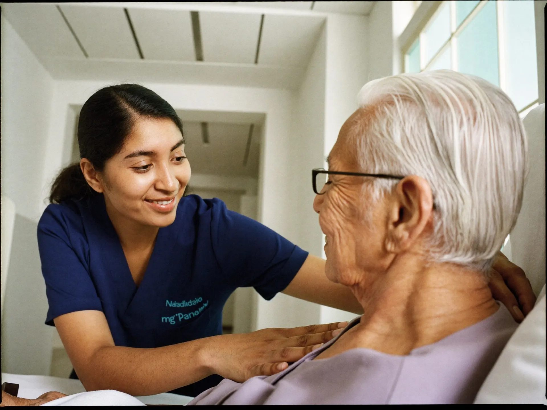 An Indian nurse in scrubs reviewing a patient chart in a hospital ward